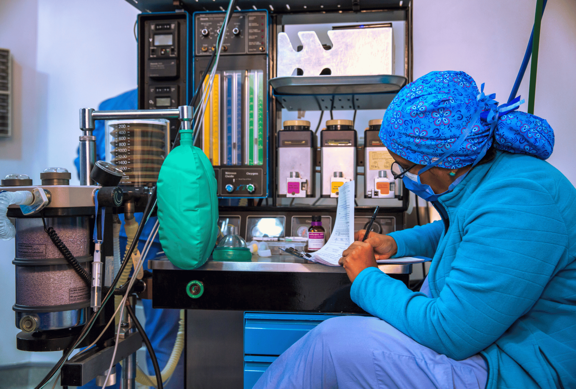 An Anesthesiologist during surgery with anesthesia machine