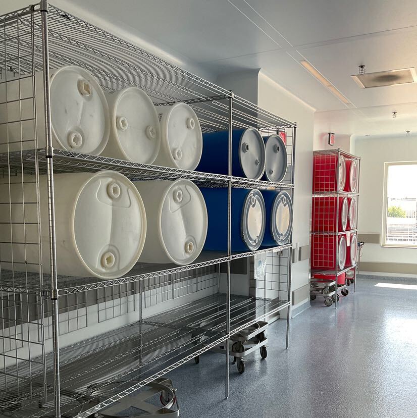 industrial plastic drums stored on a Metro super erecta shelving 