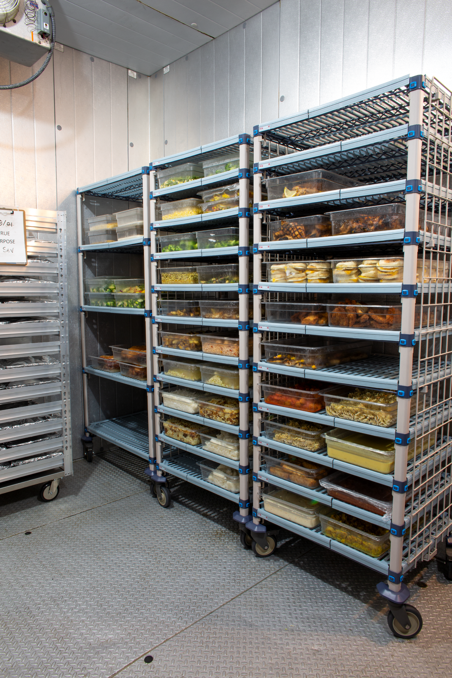 Food stored on Metromax shelving and speed racks in a walk-in