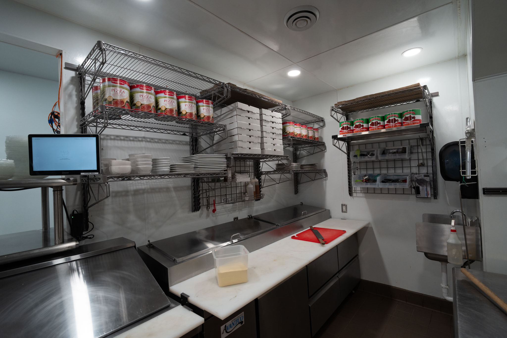 Metro SmartWall wall shelving pizza prep kit in a commercial kitchen